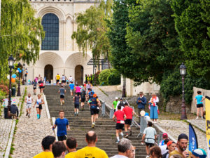 Coureurs gravissant les marches de la montée Saint-Maurice devant la cathédrale d’Angers lors d’une course solidaire pour le Téléthon.