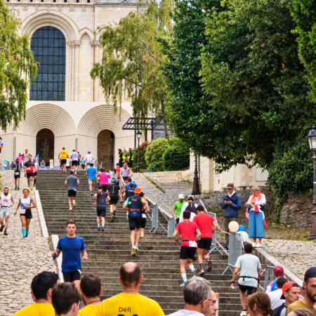 Coureurs gravissant les marches de la montée Saint-Maurice devant la cathédrale d’Angers lors d’une course solidaire pour le Téléthon.
